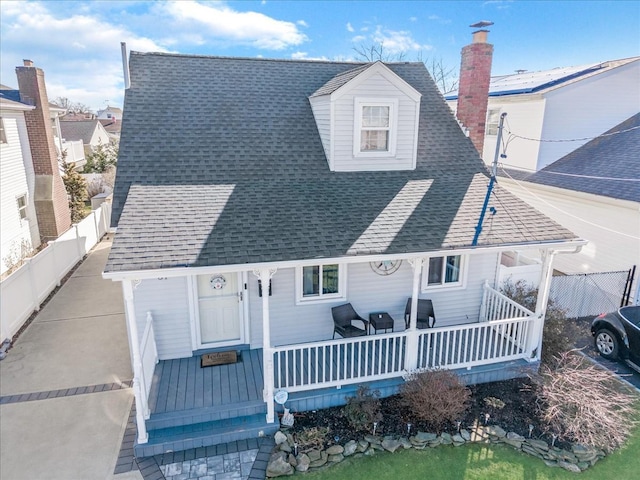 back of property with a porch