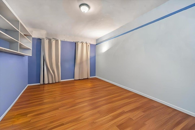 unfurnished room featuring hardwood / wood-style flooring