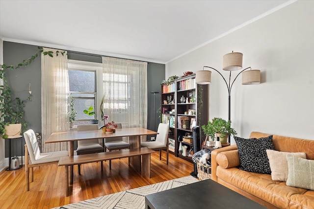 dining room with ornamental molding and hardwood / wood-style floors