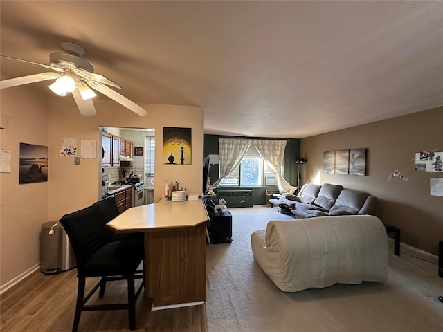 living room with ceiling fan and hardwood / wood-style floors