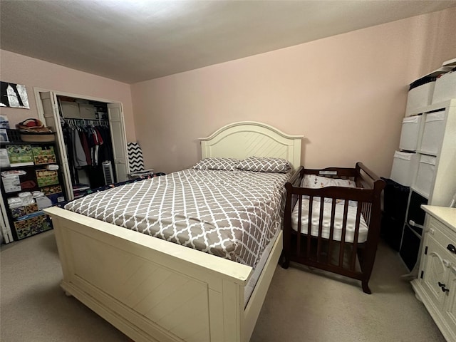 bedroom featuring light colored carpet and a closet