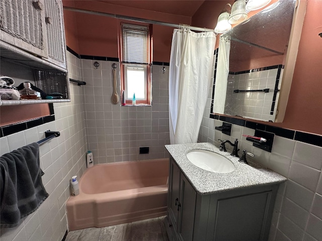 bathroom featuring hardwood / wood-style flooring, vanity, tile walls, and shower / tub combo with curtain