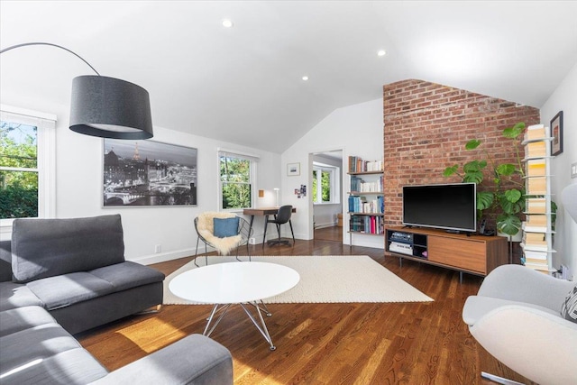 living room featuring baseboards, lofted ceiling, and wood finished floors