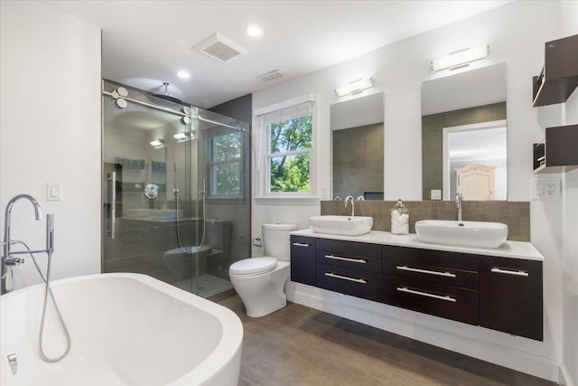 bathroom with visible vents, a stall shower, and a sink