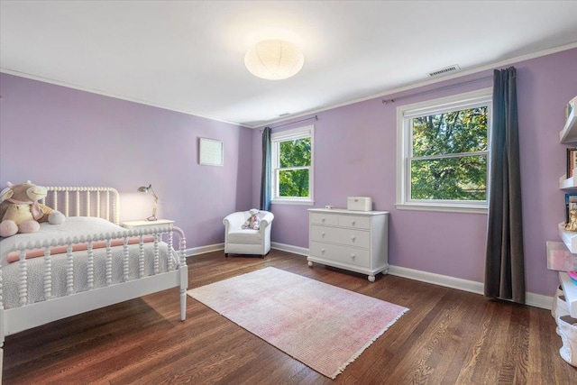 bedroom with baseboards and wood finished floors