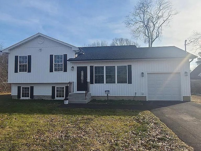 split level home featuring a garage and a front yard