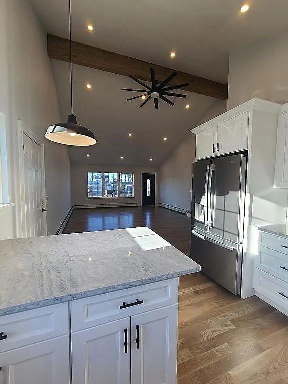 kitchen featuring decorative light fixtures, white cabinets, dark hardwood / wood-style flooring, stainless steel fridge with ice dispenser, and beam ceiling