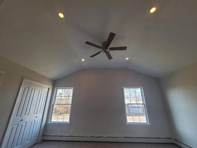 interior space with a baseboard radiator, vaulted ceiling, a wealth of natural light, and ceiling fan