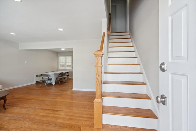 staircase featuring wood-type flooring and radiator