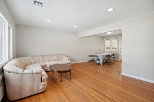 living room featuring radiator and light hardwood / wood-style floors