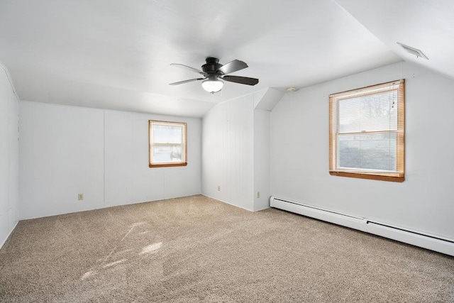 additional living space featuring vaulted ceiling, light carpet, ceiling fan, and baseboard heating