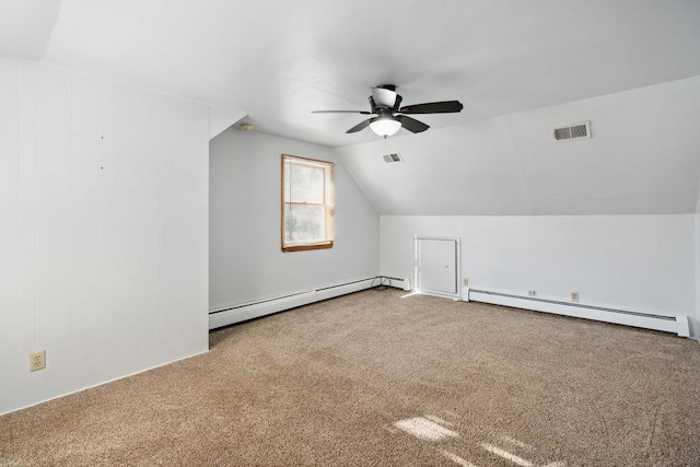 additional living space with carpet floors, a baseboard heating unit, vaulted ceiling, and ceiling fan