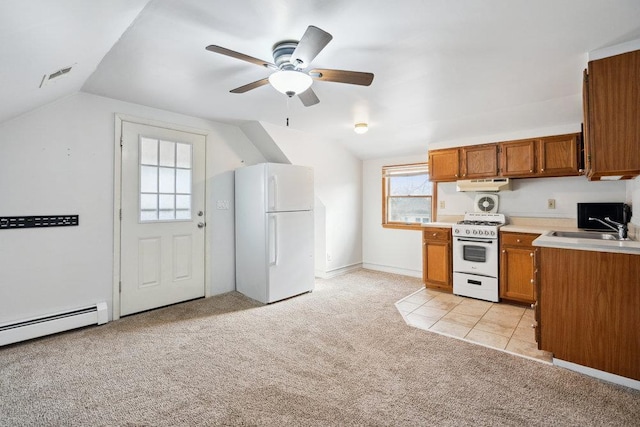 kitchen with white appliances, lofted ceiling, sink, and light colored carpet