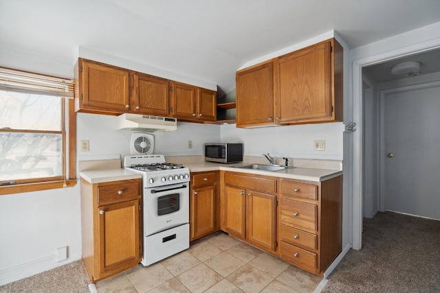 kitchen featuring vaulted ceiling, white range with gas cooktop, and sink