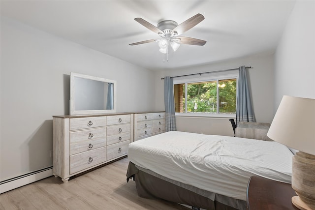 bedroom featuring ceiling fan, a baseboard heating unit, and light wood-type flooring