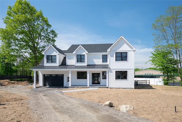 modern farmhouse style home featuring a garage and covered porch