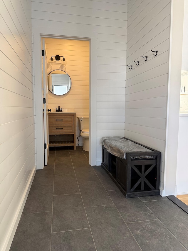 mudroom featuring dark tile patterned flooring