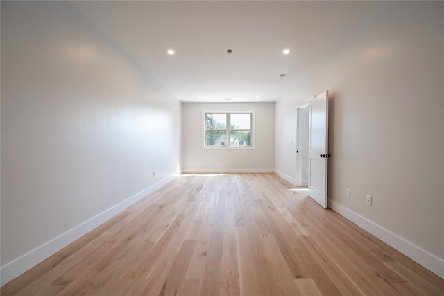 unfurnished room with light wood-type flooring