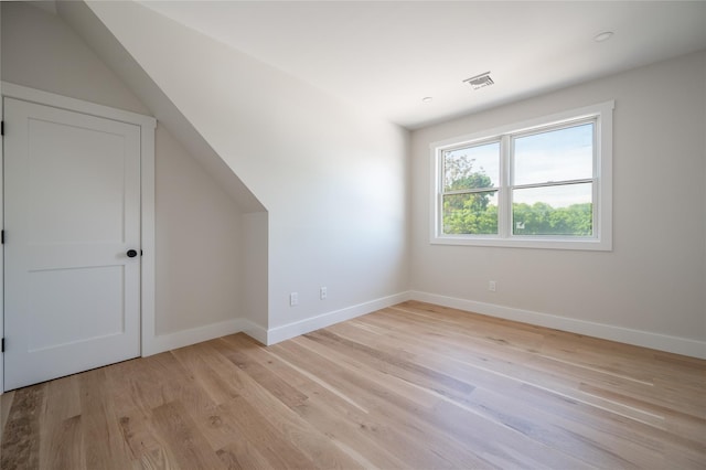 additional living space with light hardwood / wood-style flooring