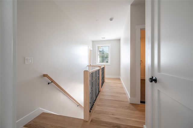 corridor with light hardwood / wood-style floors