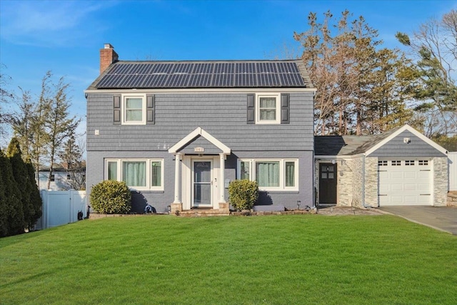 view of front facade with a front lawn and solar panels