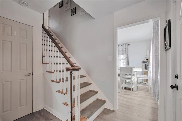 stairs with wood-type flooring