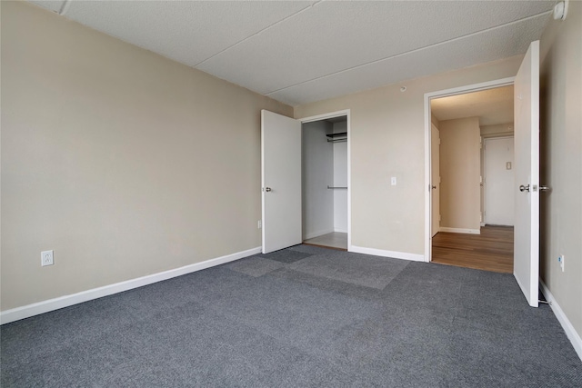 unfurnished bedroom featuring dark colored carpet