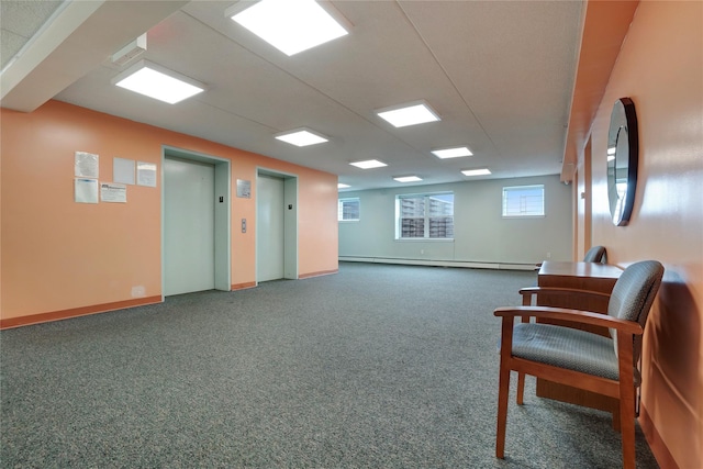 sitting room with elevator, a baseboard radiator, and dark carpet