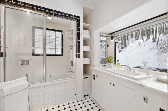 bathroom featuring vanity and shower / bath combination with glass door