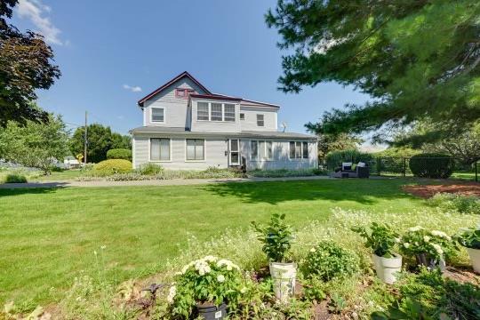 rear view of property featuring a yard