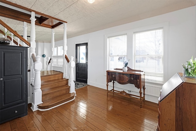 entrance foyer featuring stairway, an ornate ceiling, hardwood / wood-style flooring, and baseboards