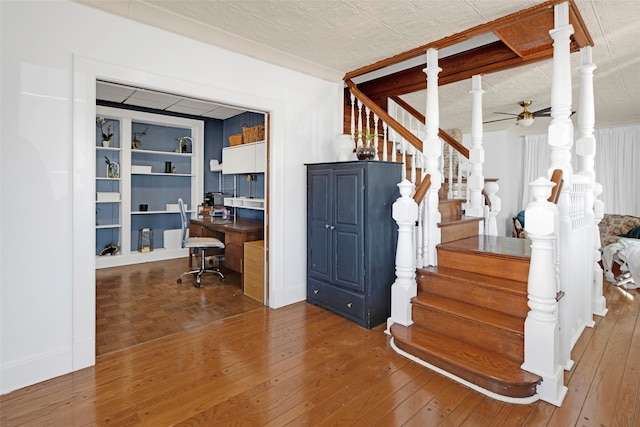 stairway featuring hardwood / wood-style flooring and a ceiling fan