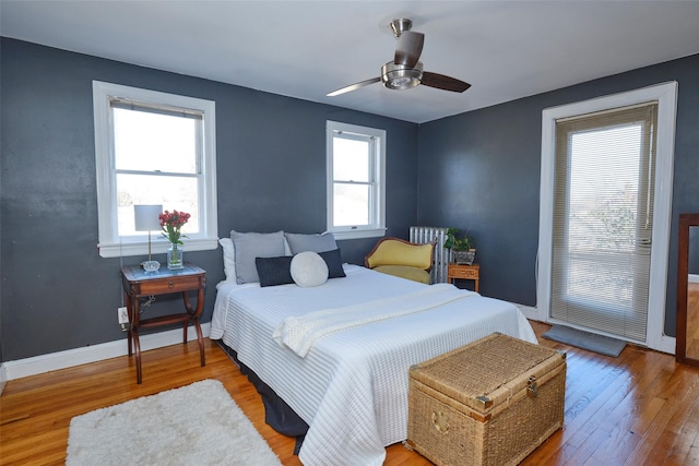 bedroom with ceiling fan, baseboards, and wood finished floors