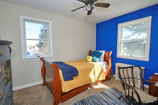 carpeted bedroom with baseboards and a ceiling fan