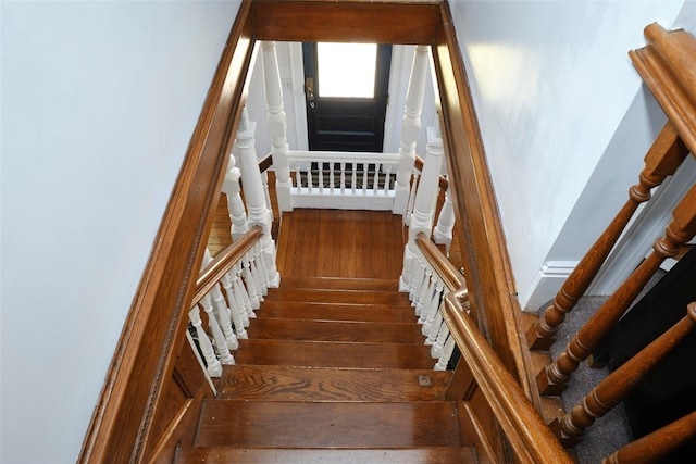 staircase featuring hardwood / wood-style flooring