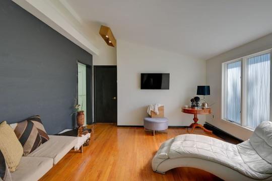 living area featuring vaulted ceiling and wood finished floors