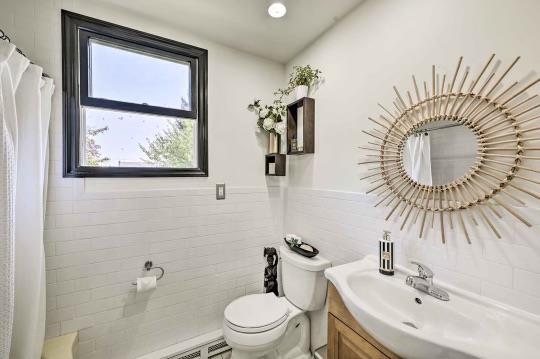 full bath with curtained shower, toilet, a wainscoted wall, vanity, and tile walls