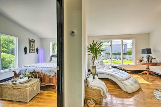 bedroom with lofted ceiling, multiple windows, and wood finished floors