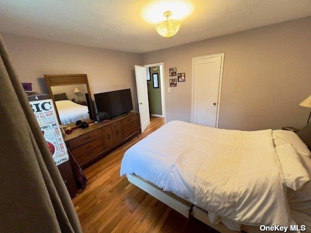 bedroom with hardwood / wood-style floors