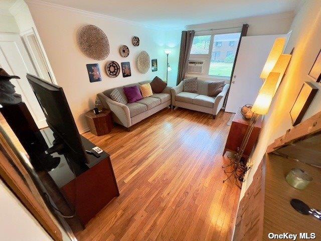 living room featuring ornamental molding and hardwood / wood-style floors