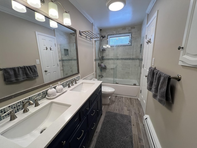 full bathroom with toilet, crown molding, wood-type flooring, shower / bath combination with glass door, and a baseboard heating unit