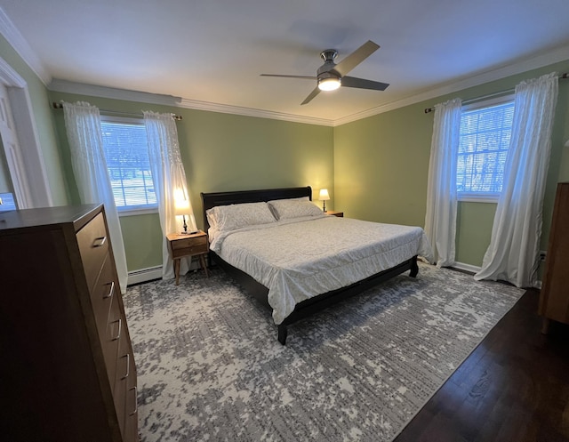 bedroom featuring crown molding, a baseboard heating unit, dark wood-type flooring, and ceiling fan