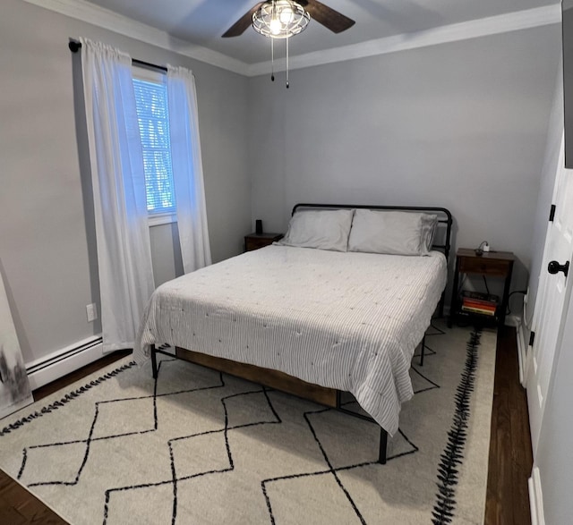 bedroom featuring crown molding, wood-type flooring, ceiling fan, and baseboard heating