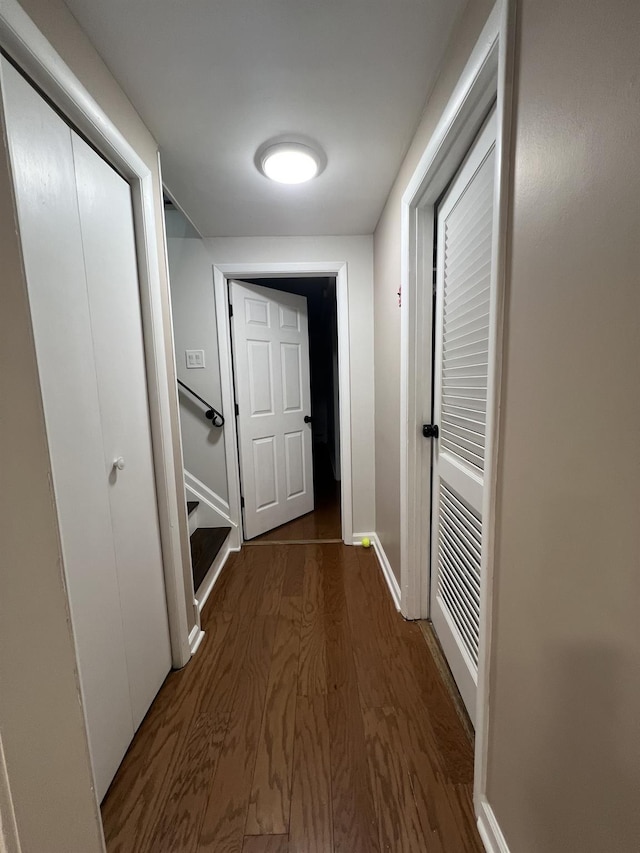 hallway with dark hardwood / wood-style floors