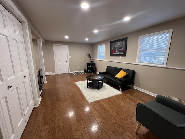 living room featuring dark hardwood / wood-style flooring and baseboard heating