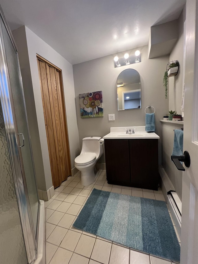 bathroom featuring tile patterned floors, toilet, a shower with shower door, vanity, and a baseboard heating unit