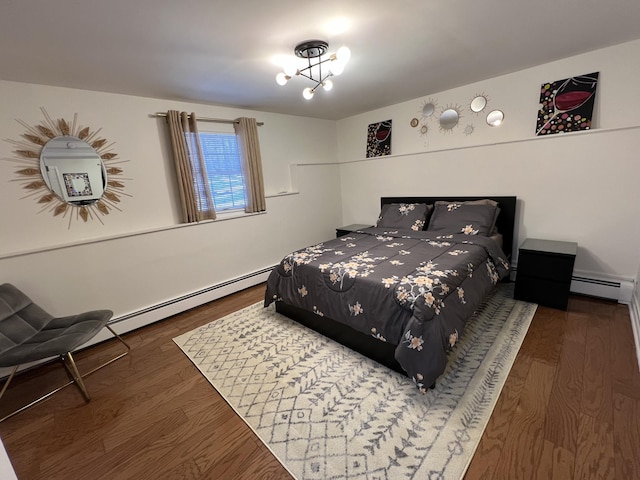 bedroom with dark hardwood / wood-style flooring and a baseboard heating unit