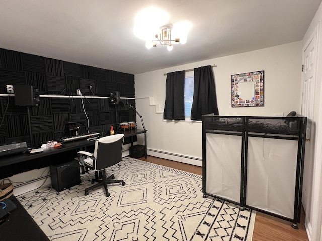 home office with light hardwood / wood-style flooring and a baseboard radiator