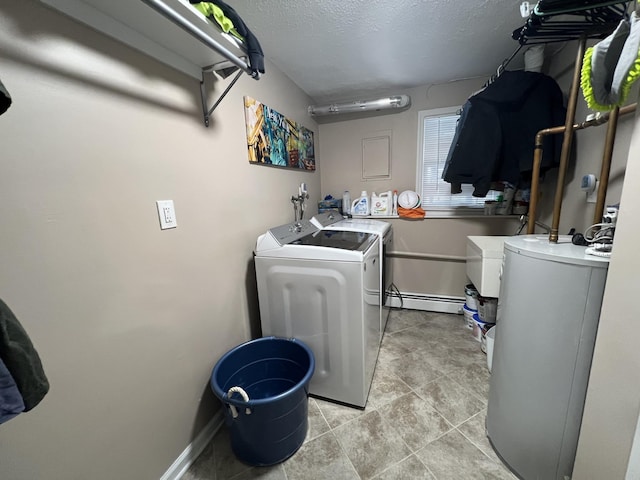 clothes washing area featuring a baseboard radiator, washer and dryer, and a textured ceiling