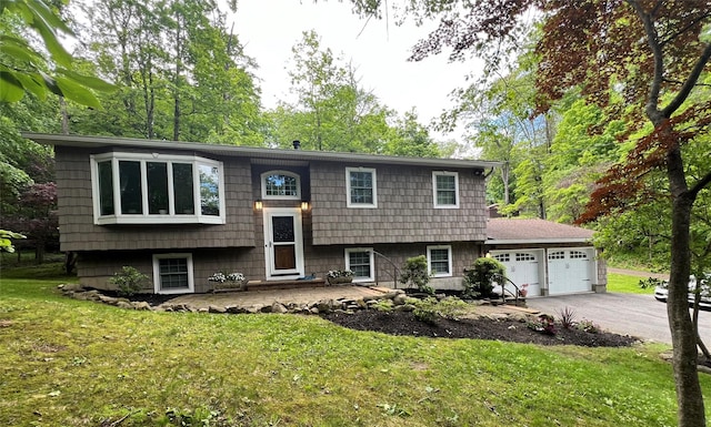 1179 E Mombasha Rd, Monroe, NY 10950 - raised ranch featuring a garage, asphalt driveway, and a front yard